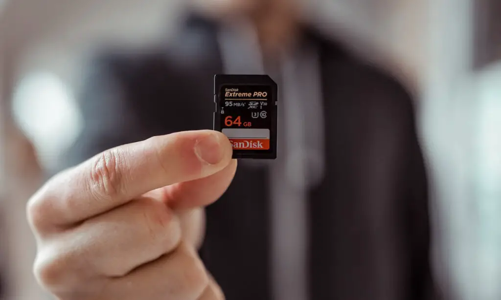 Man is holding a MICRO SD Card