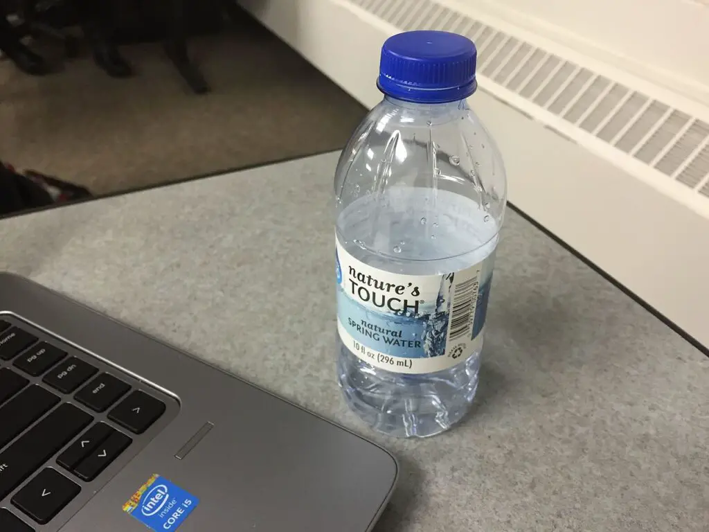 Water bottle at the side of the laptop